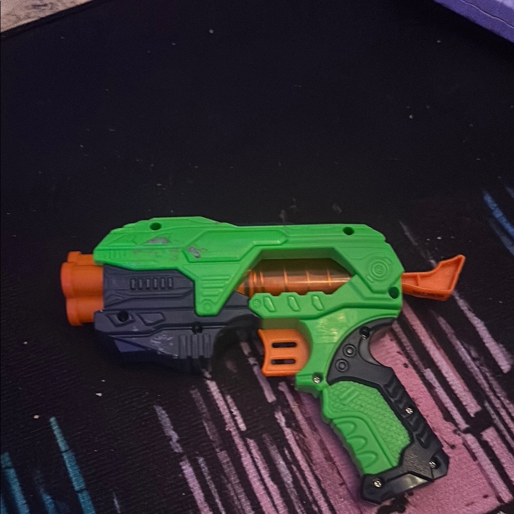 Green and Orange Toy Blaster in hood condition